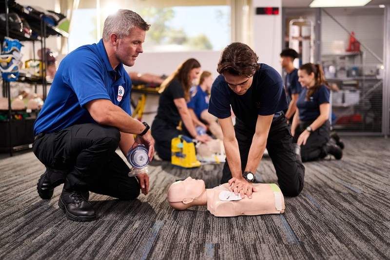 Basic Life Support student practicing CPR with an instructor